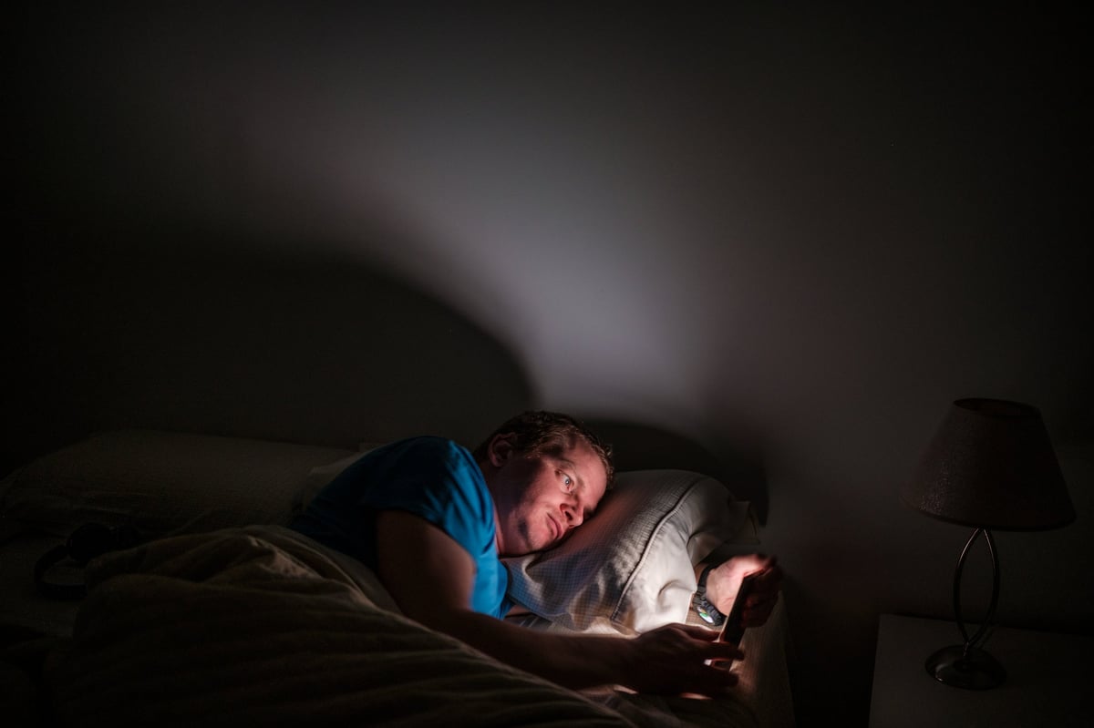 Host checking phone at night