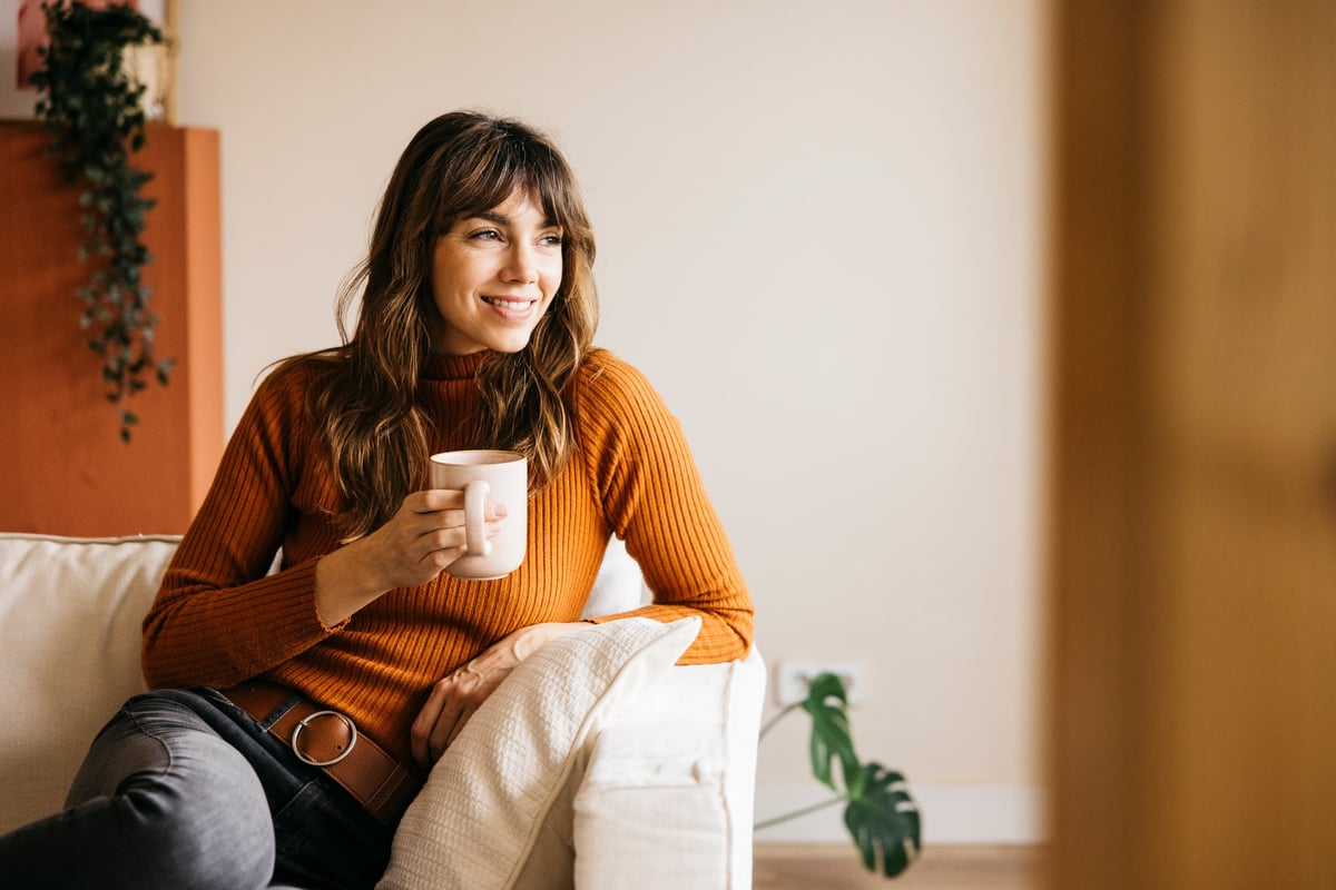 Smiling host relaxing at home